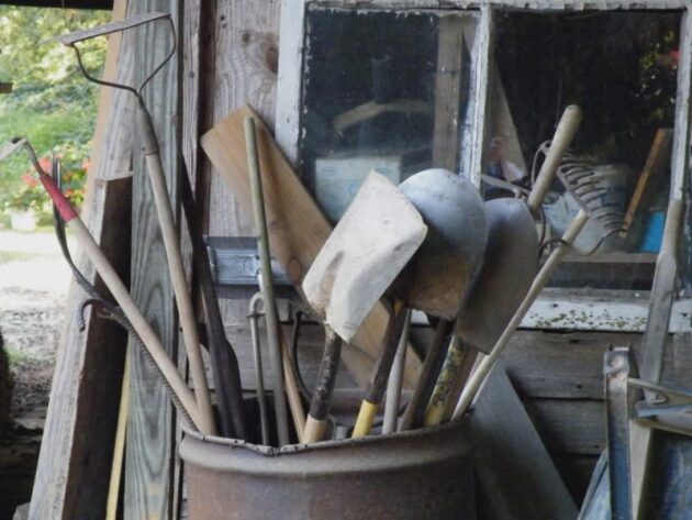 Bundle of old garden tools showing signs of wear and rust, highlighting the need for simple maintenance tasks suitable during injury recovery.
